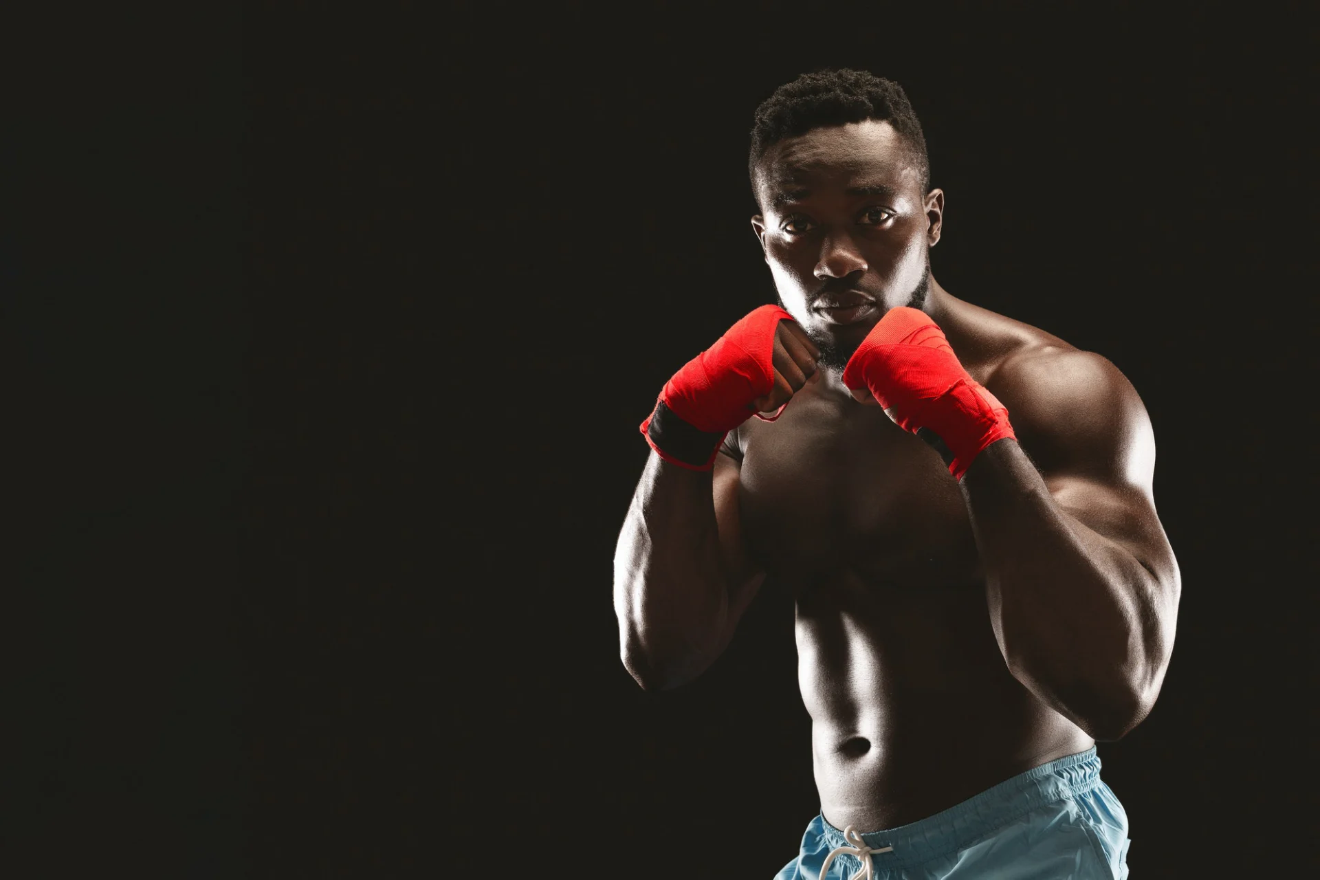 athletic-african-fighter-demonstrating-classical-boxing-stance